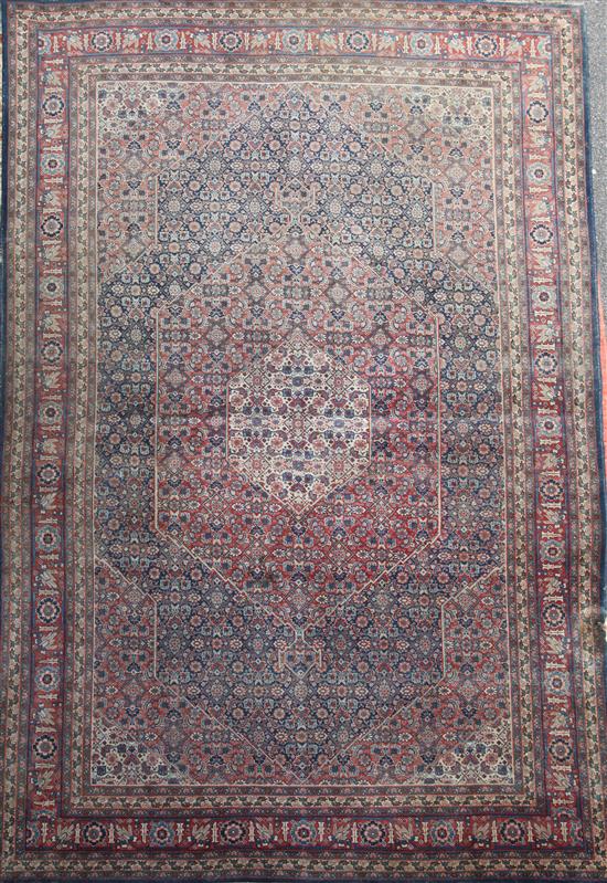 A Caucasian red and blue ground carpet, 11ft 10in by 8ft 4in.